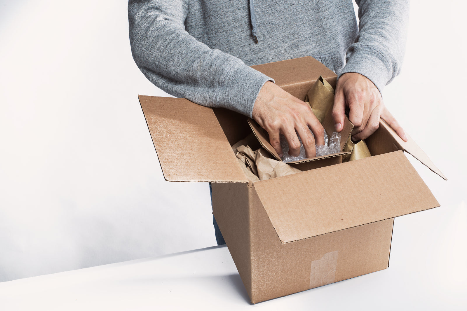 Worker packing an order into a shipping box
