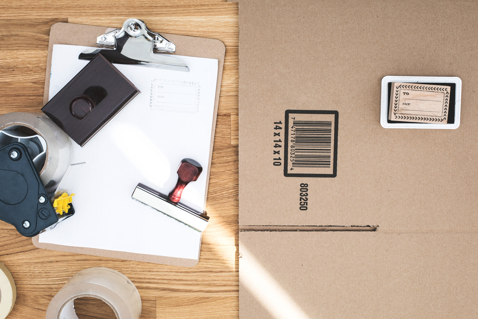 Barcoded carton with a label stamp, clipboard and packing tape