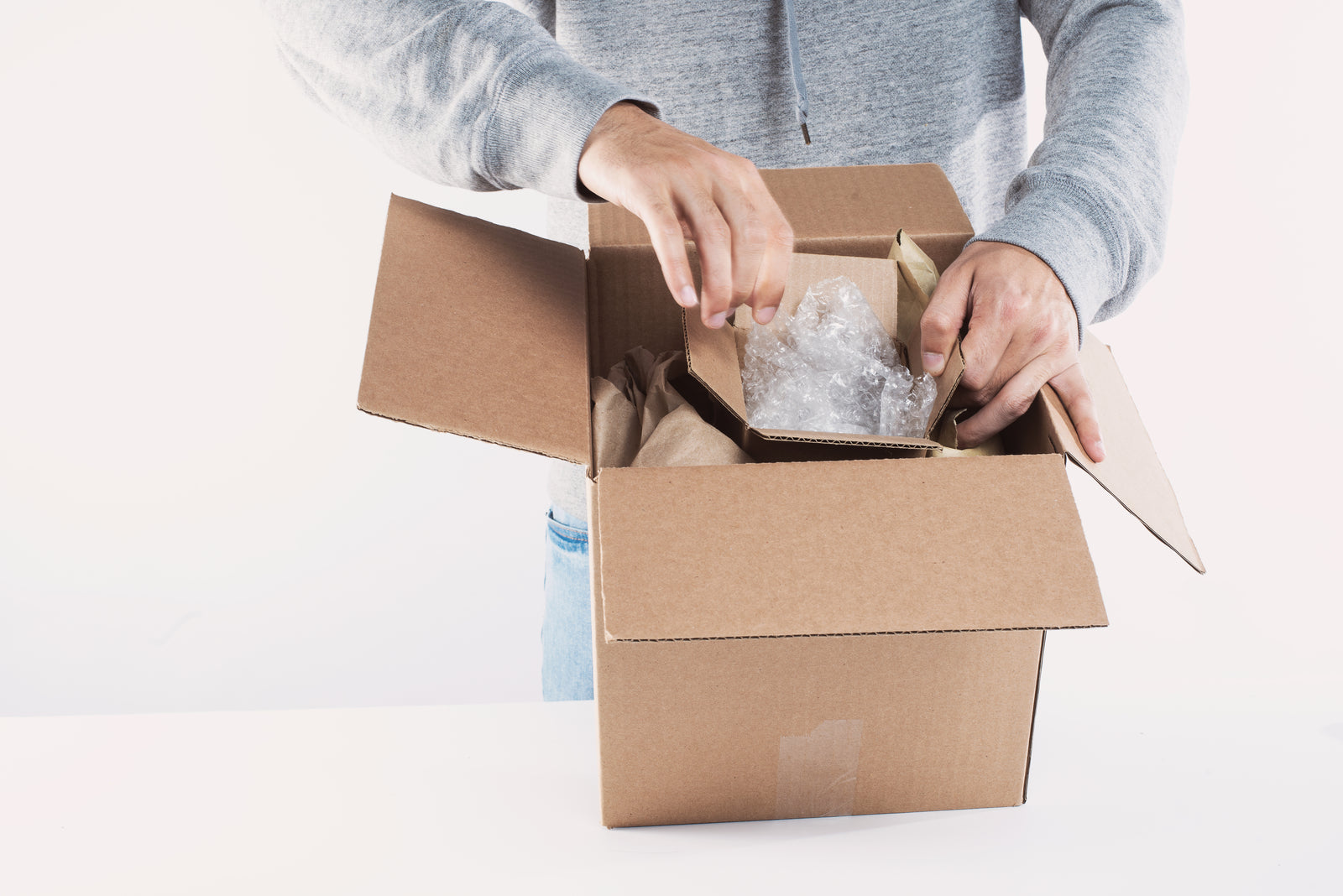 Worker opening a returned package to inspect the item