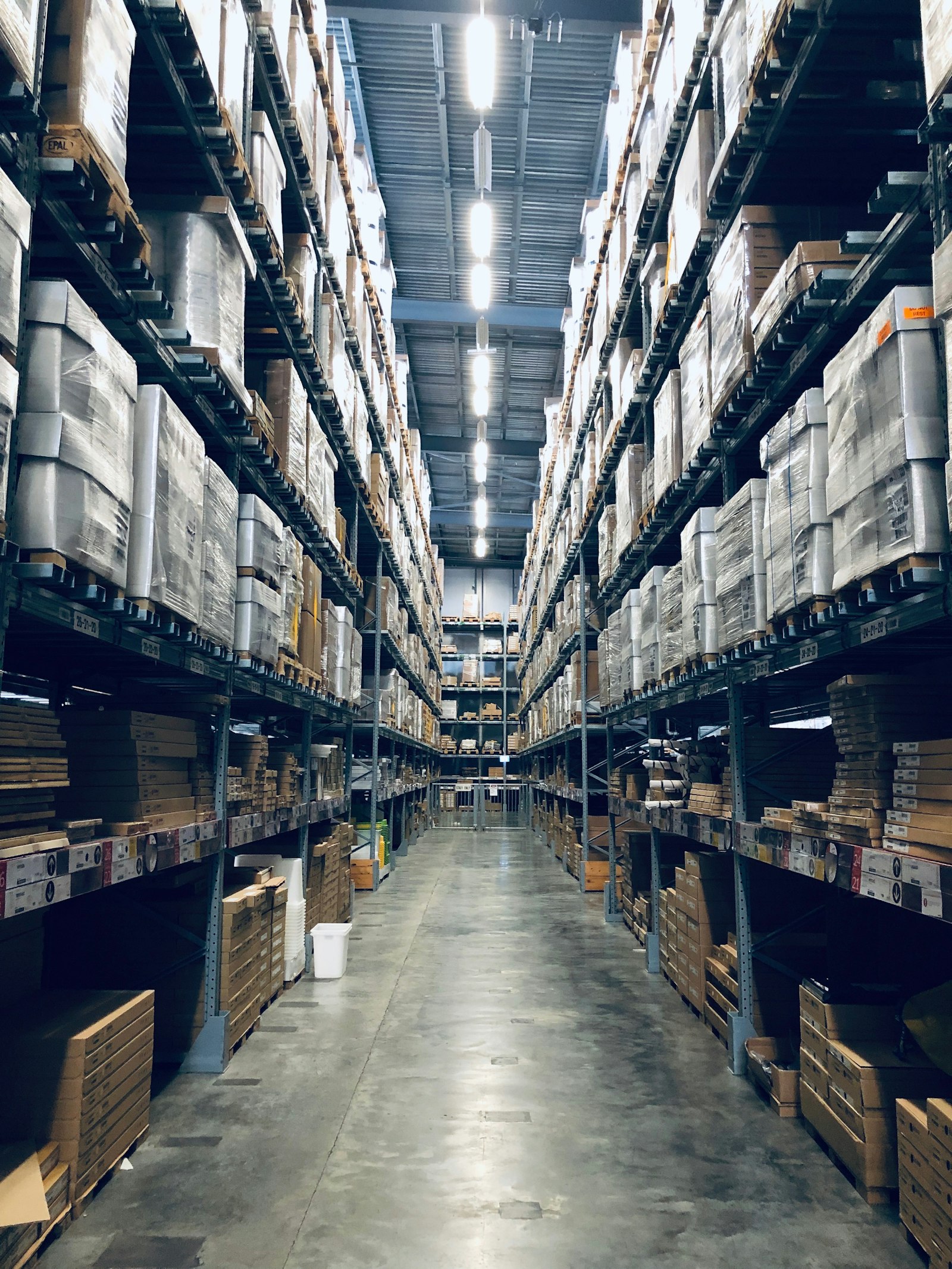 Long aisle of tall warehouse shelving